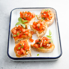 Traditional tomato bruschetta with greens