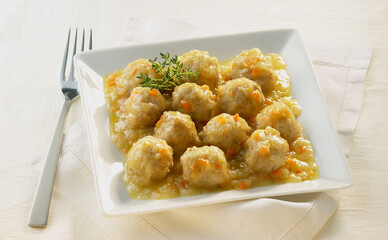 veal meatballs in sauce on white square plate