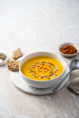 Homemade pumpkin soup with red pesto