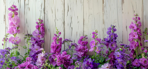 Fototapeta na wymiar A row of purple flowers are in a vase on a wooden table