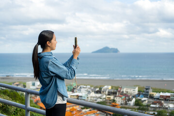 Tourist woman use mobile phone to take photo in Yilan of Taiwan