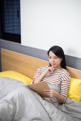 Woman read on notebook on bed - 786046649