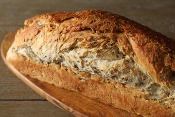 Freshly baked sourdough bread on wooden table, closeup