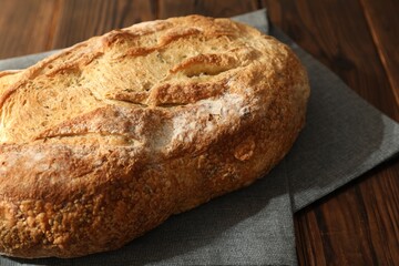 Freshly baked sourdough bread on wooden table, closeup