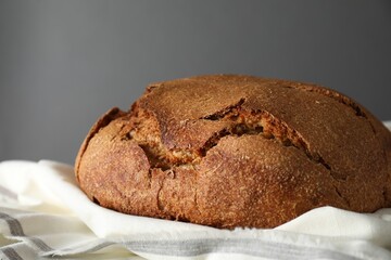 Freshly baked sourdough bread on table against grey background, closeup