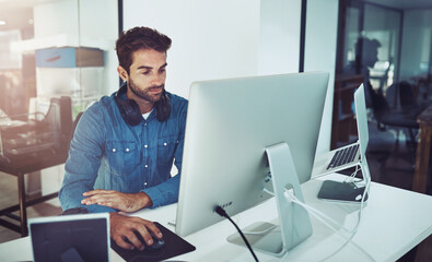 Serious, business man and computer for reading email, planning or network online in creative startup office. Pc, graphic designer and internet for project on laptop, research and info on software