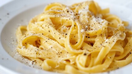 A tasty dish of cacio e pepe pasta against a white backdrop Italian cuisine