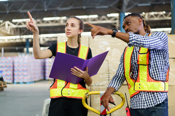 Logistic engineers or warehouse works working together in warehouse.