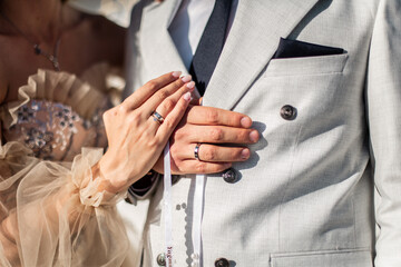 Close-up photo of the men`s holding woman hand with golden wedding ring with diamond. Wedding ring...