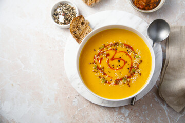 Homemade pumpkin soup with red pesto