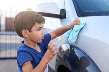 Child, car wash and cleaning or outdoor chore as youth learning for to do list, responsibility or...