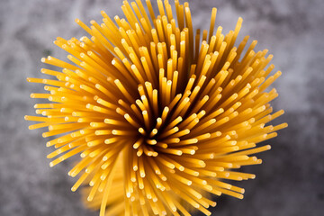 close up of raw dry spaghetti  italian pasta on table.