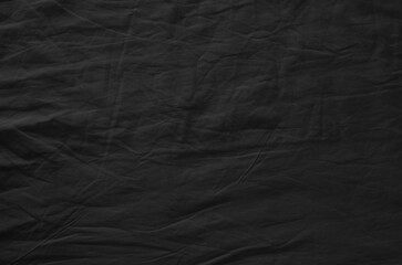 Black crumpled fabric. Background texture.