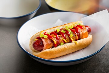 Grilled bacon wrapped hot dog with relish, ketchup and mustard