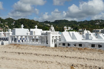 White tombstones and graves in a cemetery near the beach in Castries, Saint Lucia, one of the...