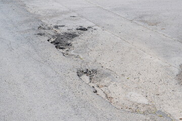 bad potholes on a road in Germany