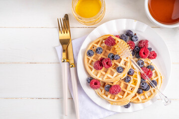 Sweet breakfast belgian waffles with fruit berry