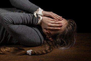 Tied girl on the floor. Stop abusing child violence, human trafficking, Human Rights Day concept