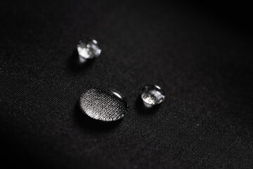 water drops on dark textile. close up. macro