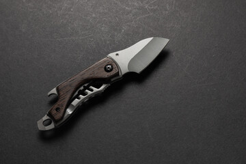 tactical folding knife. EDC knife. on dark background