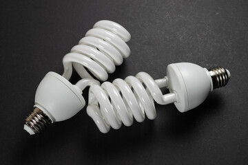 Energy saving fluorescent light bulb on dark background