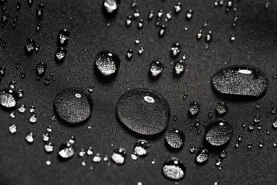 Water drops on waterproof black fabric