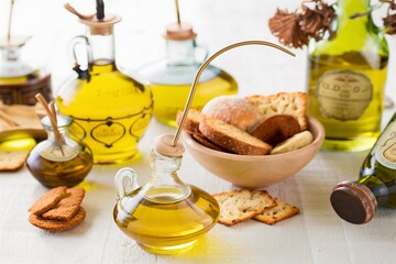 Olive oil in vintage bottles and small bowl