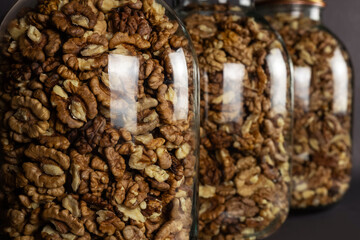 Shelled walnuts inside jar glass close up