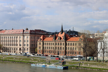 Fototapeta na wymiar Architecture of Bratislava, Slovakia. View on old town from Danube river. Cloudy spring day. Panoramic photo of beautiful old buildings. Tourist destinations concept. 
