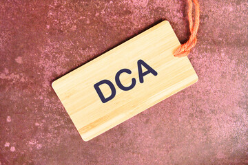 Business concept. Dollar cost averaging investment strategy. DCA on a card with a rope on an...