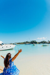 Woman on vacation on a tropical island. Travel person on Mauritius island looking at the turquoise ocean