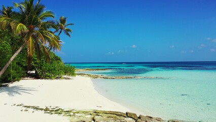 Beautiful tropical island with palm trees on a sandy beach on a sunny day