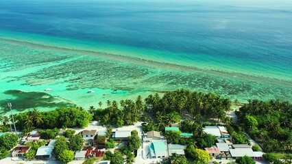 Aerial view of a beautiful tropical island with palm trees and clear water