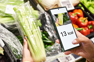 Checking calories on celery vegetable with smartphone