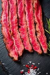 tasty steak with pepper and salt