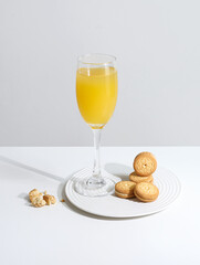 A drink and cookies on the white table top