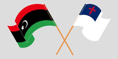 Crossed and waving flags of Libya and christianity