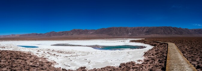 Panoramic view of an oasis with turquoise water lagoon in the Atacama desert, Chile