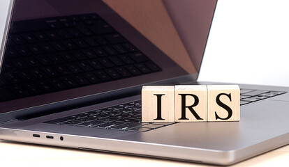 IRS word on wooden block on laptop , business concept