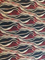 The red and black wavy pattern of the carpet