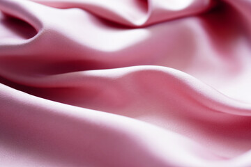 Pink silk or satin background, wavy, elegant and elegant. Close-up, background. Space for designblur or blurry