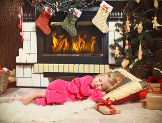 Little cute girl sleeping under the Christmas Tree waiting for Santa