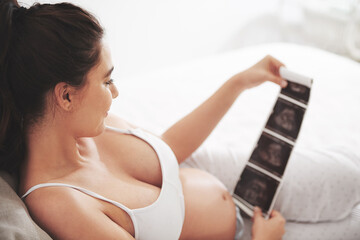 Pregnant woman, sonogram and ultrasound with home, bedroom and relaxing mom. Mother, maternity and...