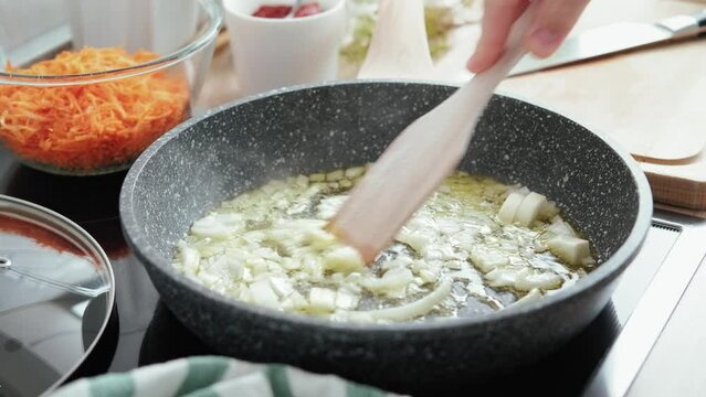 Onions frying in a frying pan. Cooking process, stock footage video 4k