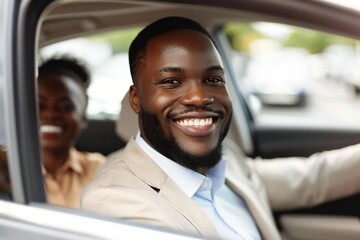Happy African American man driving car, smiling widely - obrazy, fototapety, plakaty