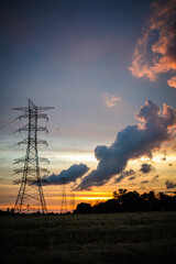 High voltage electricity tower sky sunset landscape, industrial background.