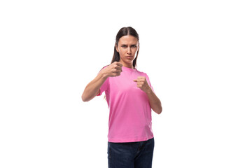 young good-looking woman with black hair dressed in a pink t-shirt actively gesticulates - obrazy, fototapety, plakaty