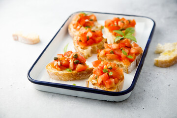 Traditional tomato bruschetta with greens