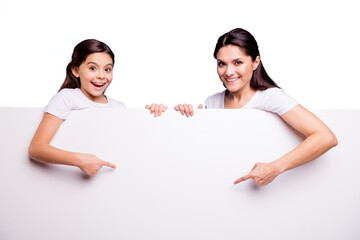 Close up photo two people brown haired mom little daughter toothy beaming smile blank signboard poster arms finger show white poster on sale discount wearing t-shirts isolated bright blue background