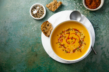 Homemade pumpkin soup with red pesto